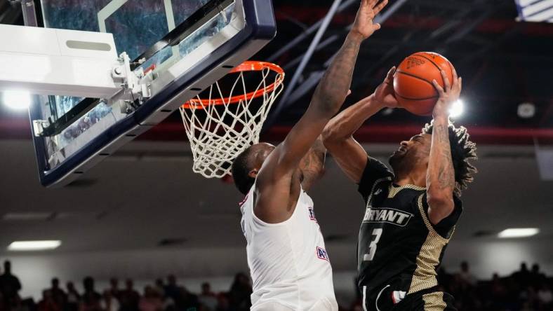 Nov 18, 2023; Boca Raton, Florida, USA;  Bryant University Bulldogs guard Sherif Gross-Bullock (3) shoots against Florida Atlantic Owls guard Johnell Davis (1) during the second half at Eleanor R. Baldwin Arena. Mandatory Credit: Rich Storry-USA TODAY Sports