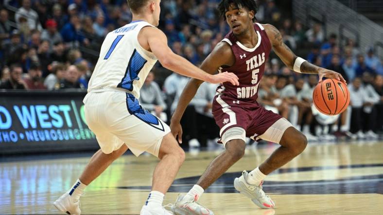 Nov 18, 2023; Omaha, Nebraska, USA; Texas Southern Tigers guard Jaylen Wysinger (5) dribbles against Creighton Bluejays guard Steven Ashworth (1) in the first half at CHI Health Center Omaha. Mandatory Credit: Steven Branscombe-USA TODAY Sports