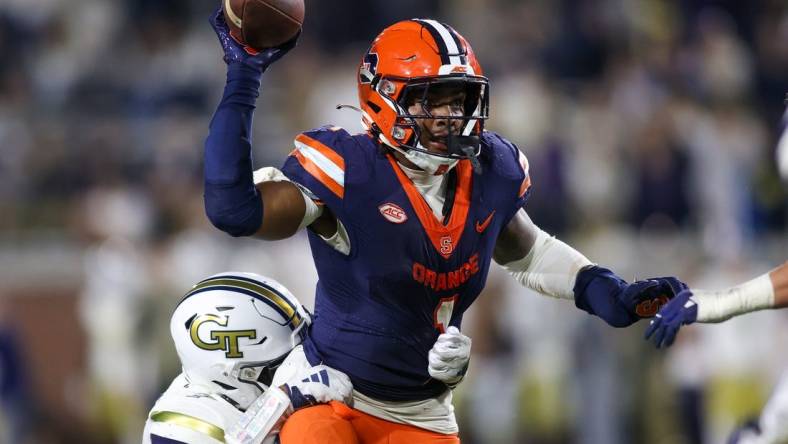 Nov 18, 2023; Atlanta, Georgia, USA; Syracuse Orange running back LeQuint Allen (1) is pressured by Georgia Tech Yellow Jackets linebacker Trenilyas Tatum (7) in the second half at Bobby Dodd Stadium at Hyundai Field. Mandatory Credit: Brett Davis-USA TODAY Sports