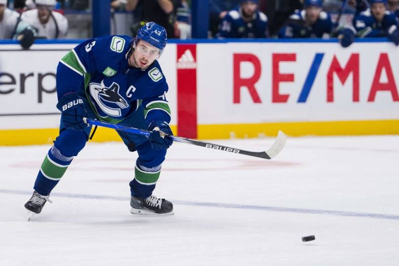 Nov 18, 2023; Vancouver, British Columbia, CAN; Vancouver Canucks defenseman Quinn Hughes (43) makes a pass against the Seattle Kraken in the third period at Rogers Arena. Seattle won 4-3. Mandatory Credit: Bob Frid-USA TODAY Sports