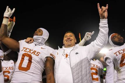 Nov 18, 2023; Ames, Iowa, USA; Texas Longhorns head coach Steve Sarkisian and linebacker Anthony Hill Jr. (0) hold up the sign of the horns after their win over the Iowa State Cyclones at Jack Trice Stadium. Mandatory Credit: Aaron E. Martinez-USA TODAY Sports