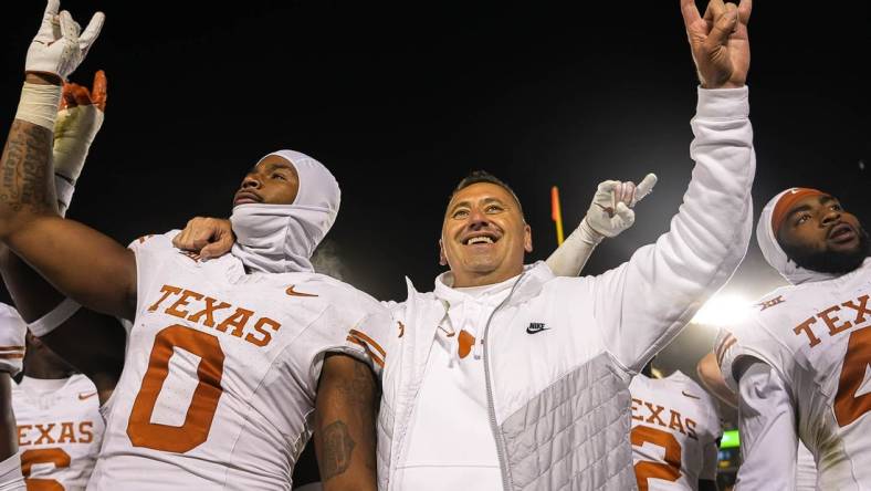 Nov 18, 2023; Ames, Iowa, USA; Texas Longhorns head coach Steve Sarkisian and linebacker Anthony Hill Jr. (0) hold up the sign of the horns after their win over the Iowa State Cyclones at Jack Trice Stadium. Mandatory Credit: Aaron E. Martinez-USA TODAY Sports