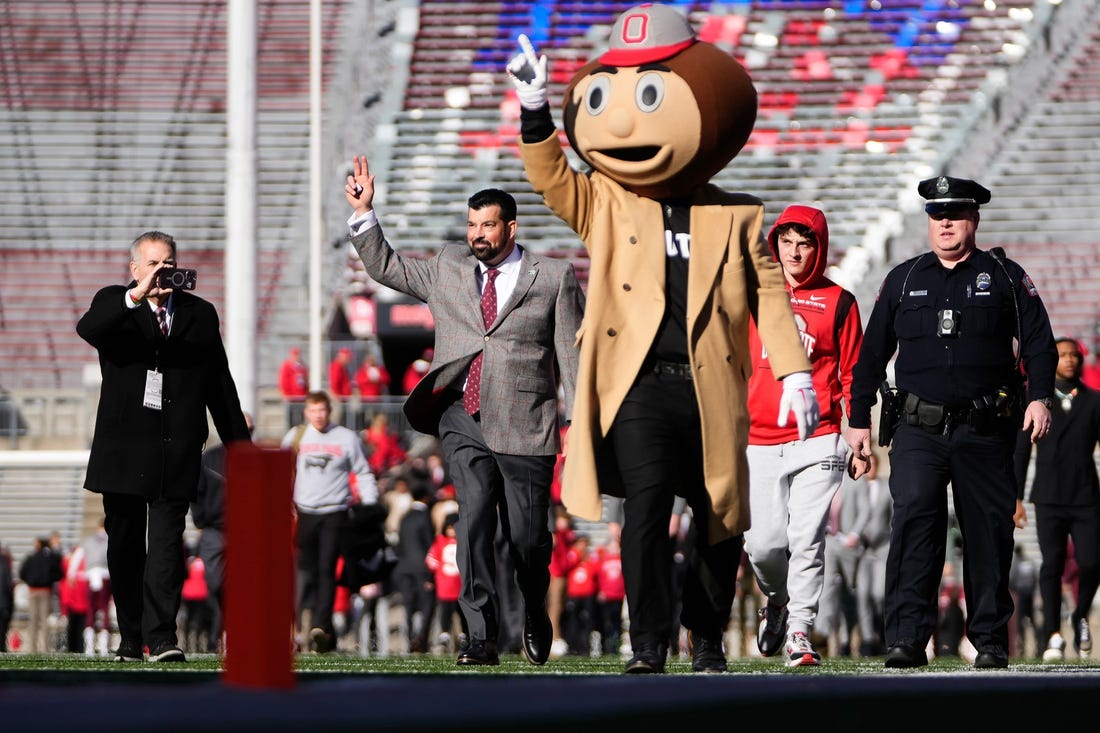 Nov 18, 2023; Columbus, Ohio, USA; Ohio State Buckeyes head coach Ryan Day walks into Ohio Stadium behind Brutus Buckeye prior to the NCAA football game against the Minnesota Golden Gophers.