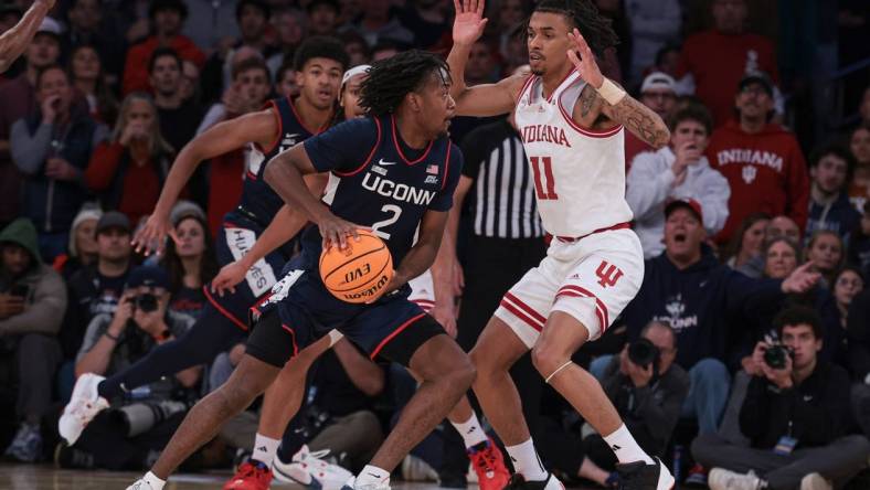 Nov 19, 2023; New York, New York, USA; Connecticut Huskies guard Tristen Newton (2) dribbles as Indiana Hoosiers guard CJ Gunn (11) defends during the second half at Madison Square Garden. Mandatory Credit: Vincent Carchietta-USA TODAY Sports