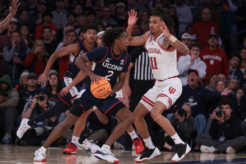 Nov 19, 2023; New York, New York, USA; Connecticut Huskies guard Tristen Newton (2) dribbles as Indiana Hoosiers guard CJ Gunn (11) defends during the second half at Madison Square Garden. Mandatory Credit: Vincent Carchietta-USA TODAY Sports