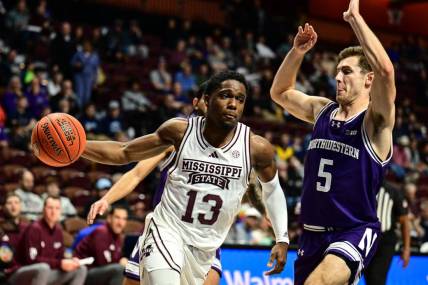 Nov 19, 2023; Uncasville, CT, USA;  Mississippi State Bulldogs guard Josh Hubbard (13) dribbles the ball challenged by Northwestern Wildcats guard Ryan Langborg (5) during the second halfat Mohegan Sun Arena. Mandatory Credit: Mark Smith-USA TODAY Sports