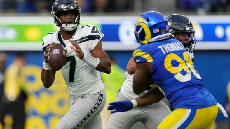 Nov 19, 2023; Inglewood, California, USA; Seattle Seahawks quarterback Geno Smith (7) looks to pass against the Los Angeles Rams in the second quarter at SoFi Stadium. Mandatory Credit: Kirby Lee-USA TODAY Sports