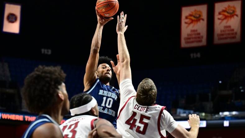 Nov 19, 2023; Uncasville, CT, USA; Washington State Cougars forward Oscar Cluff (45) jumps to block a shot by Rhode Island Rams forward Tyson Brown (10) during the first half at Mohegan Sun Arena. Mandatory Credit: Mark Smith-USA TODAY Sports