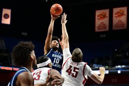Nov 19, 2023; Uncasville, CT, USA; Washington State Cougars forward Oscar Cluff (45) jumps to block a shot by Rhode Island Rams forward Tyson Brown (10) during the first half at Mohegan Sun Arena. Mandatory Credit: Mark Smith-USA TODAY Sports