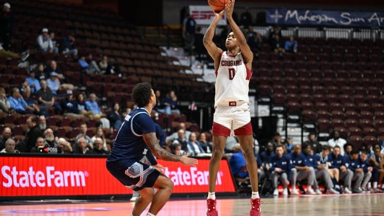 Nov 19, 2023; Uncasville, CT, USA; Washington State Cougars forward Jaylen Wells (0) shoots the ball over Rhode Island Rams guard Luis Kortright (1) during the second half at Mohegan Sun Arena. Mandatory Credit: Mark Smith-USA TODAY Sports