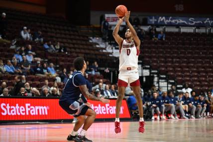 Nov 19, 2023; Uncasville, CT, USA; Washington State Cougars forward Jaylen Wells (0) shoots the ball over Rhode Island Rams guard Luis Kortright (1) during the second half at Mohegan Sun Arena. Mandatory Credit: Mark Smith-USA TODAY Sports
