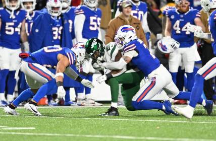 Nov 19, 2023; Orchard Park, New York, USA; Buffalo Bills safety Taylor Rapp (left) was injured on a tackle of New York Jets running back Breece Hall (20) requiring an ambulance in the second quarter. Also in the play is Buffalo Bills cornerback Taron Johnson (7) at Highmark Stadium. Mandatory Credit: Mark Konezny-USA TODAY Sports
