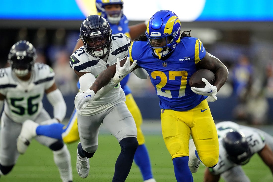 Nov 19, 2023; Inglewood, California, USA; Los Angeles Rams running back Darrell Henderson Jr. (27) runs against Seattle Seahawks cornerback Devon Witherspoon (21) in the second half at SoFi Stadium. Mandatory Credit: Kirby Lee-USA TODAY Sports