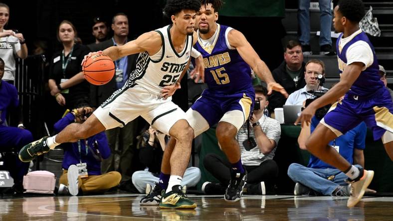 Nov 19, 2023; East Lansing, Michigan, USA;  Michigan State Spartans forward Malik Hall (25) drives past Alcorn State Braves forward Djahi Binet (15) during the first half at Jack Breslin Student Events Center. Mandatory Credit: Dale Young-USA TODAY Sports