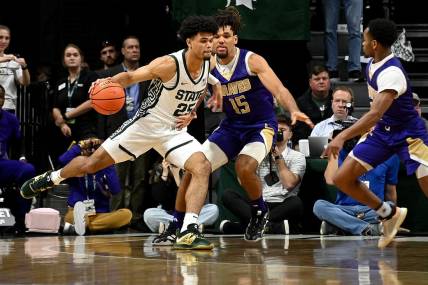 Nov 19, 2023; East Lansing, Michigan, USA;  Michigan State Spartans forward Malik Hall (25) drives past Alcorn State Braves forward Djahi Binet (15) during the first half at Jack Breslin Student Events Center. Mandatory Credit: Dale Young-USA TODAY Sports