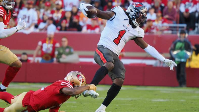 Nov 19, 2023; Santa Clara, California, USA; San Francisco 49ers wide receiver Isaiah Winstead (2) holds onto the ankle of Tampa Bay Buccaneers running back Rachaad White (1) during the fourth quarter at Levi's Stadium. Mandatory Credit: Kelley L Cox-USA TODAY Sports