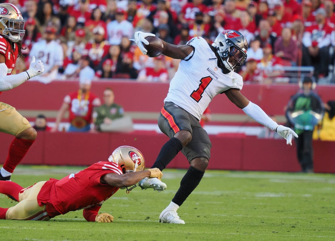 Nov 19, 2023; Santa Clara, California, USA; San Francisco 49ers wide receiver Isaiah Winstead (2) holds onto the ankle of Tampa Bay Buccaneers running back Rachaad White (1) during the fourth quarter at Levi's Stadium. Mandatory Credit: Kelley L Cox-USA TODAY Sports