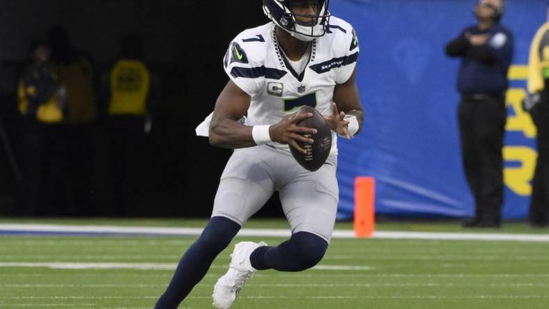 Nov 19, 2023; Inglewood, California, USA; Seattle Seahawks quarterback Geno Smith (7) controls the ball in the third quarter against the Los Angeles Rams at SoFi Stadium. Mandatory Credit: Robert Hanashiro-USA TODAY Sports