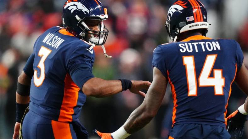 Nov 19, 2023; Denver, Colorado, USA; Denver Broncos quarterback Russell Wilson (3) and wide receiver Courtland Sutton (14) before the game at Empower Field at Mile High. Mandatory Credit: Ron Chenoy-USA TODAY Sports