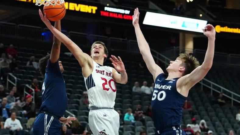 Nov 19, 2023; Las Vegas, NV, USA; St. Mary's Gaels guard Aidan Mahaney (20) shoots between Xavier Musketeers guard Dailyn Swain (3) and forward Gytis Nemeiksa (50) during the first half at T-Mobile Arena. Mandatory Credit: Stephen R. Sylvanie-USA TODAY Sports