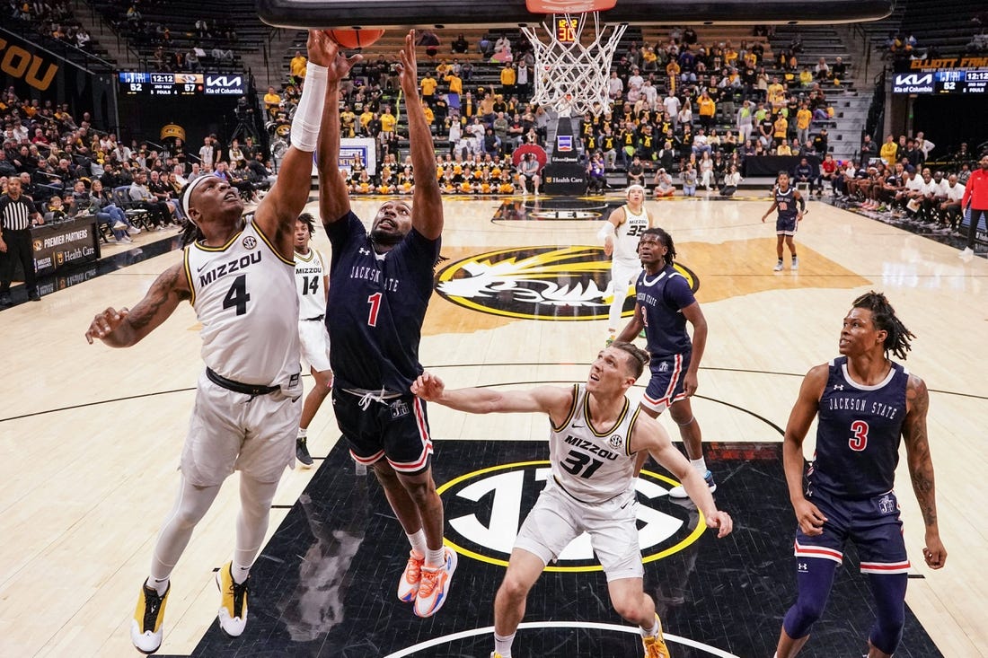 Missouri Tigers guard Curt Lewis (4) shoots a layup as Jackson State Tigers forward Zeke Cook (1) defends during the second half at Mizzou Arena. Mandatory Credit: Denny Medley-USA TODAY Sports