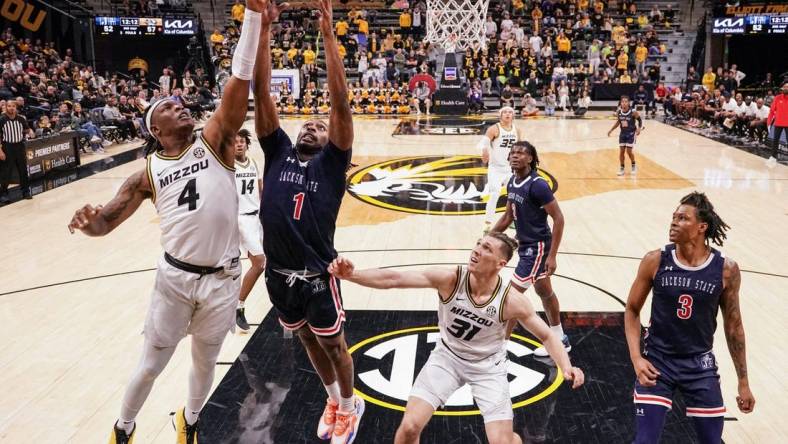 Missouri Tigers guard Curt Lewis (4) shoots a layup as Jackson State Tigers forward Zeke Cook (1) defends during the second half at Mizzou Arena. Mandatory Credit: Denny Medley-USA TODAY Sports