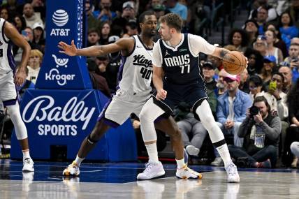 Nov 19, 2023; Dallas, Texas, USA; Dallas Mavericks guard Luka Doncic (77) looks to move the ball past Sacramento Kings forward Harrison Barnes (40) during the second half at the American Airlines Center. Mandatory Credit: Jerome Miron-USA TODAY Sports
