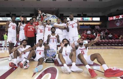 Nov 19, 2023; Charleston, SC, USA; The Houston Cougars with the champions trophy after winning the 2023 Charleston Classic at TD Arena. Mandatory Credit: David Yeazell-USA TODAY Sports