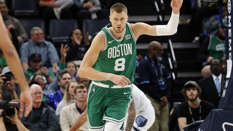 Nov 19, 2023; Memphis, Tennessee, USA; Boston Celtics center Kristaps Porzingis (8) reacts after a dunk during the second half against the Memphis Grizzlies at FedExForum. Mandatory Credit: Petre Thomas-USA TODAY Sports