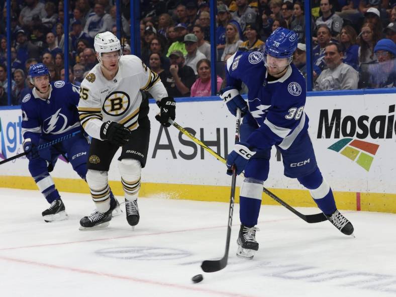 Nov 20, 2023; Tampa, Florida, USA; Tampa Bay Lightning left wing Brandon Hagel (38) passes the puck against the Boston Bruins during the first period at Amalie Arena. Mandatory Credit: Kim Klement Neitzel-USA TODAY Sports