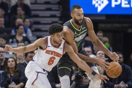 Nov 20, 2023; Minneapolis, Minnesota, USA; New York Knicks guard Quentin Grimes (6) and Minnesota Timberwolves center Rudy Gobert (27) go after a loose ball in the first half at Target Center. Mandatory Credit: Jesse Johnson-USA TODAY Sports