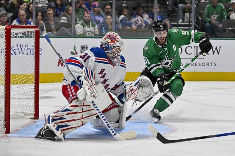 Nov 20, 2023; Dallas, Texas, USA; Dallas Stars center Tyler Seguin (91) calls for the puck in front of New York Rangers goaltender Igor Shesterkin (31) during the second period at the American Airlines Center. Mandatory Credit: Jerome Miron-USA TODAY Sports
