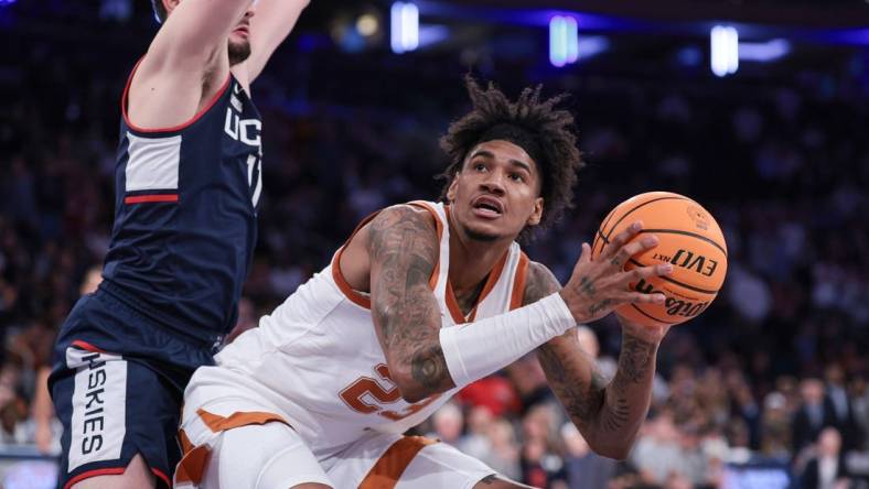 Nov 20, 2023; New York, NY, USA; Texas Longhorns forward Dillon Mitchell (23) drives to the basket against Connecticut Huskies forward Alex Karaban (11) during the second half of the Empire Classic championship game at Madison Square Garden. Mandatory Credit: Vincent Carchietta-USA TODAY Sports