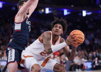 Nov 20, 2023; New York, NY, USA; Texas Longhorns forward Dillon Mitchell (23) drives to the basket against Connecticut Huskies forward Alex Karaban (11) during the second half of the Empire Classic championship game at Madison Square Garden. Mandatory Credit: Vincent Carchietta-USA TODAY Sports
