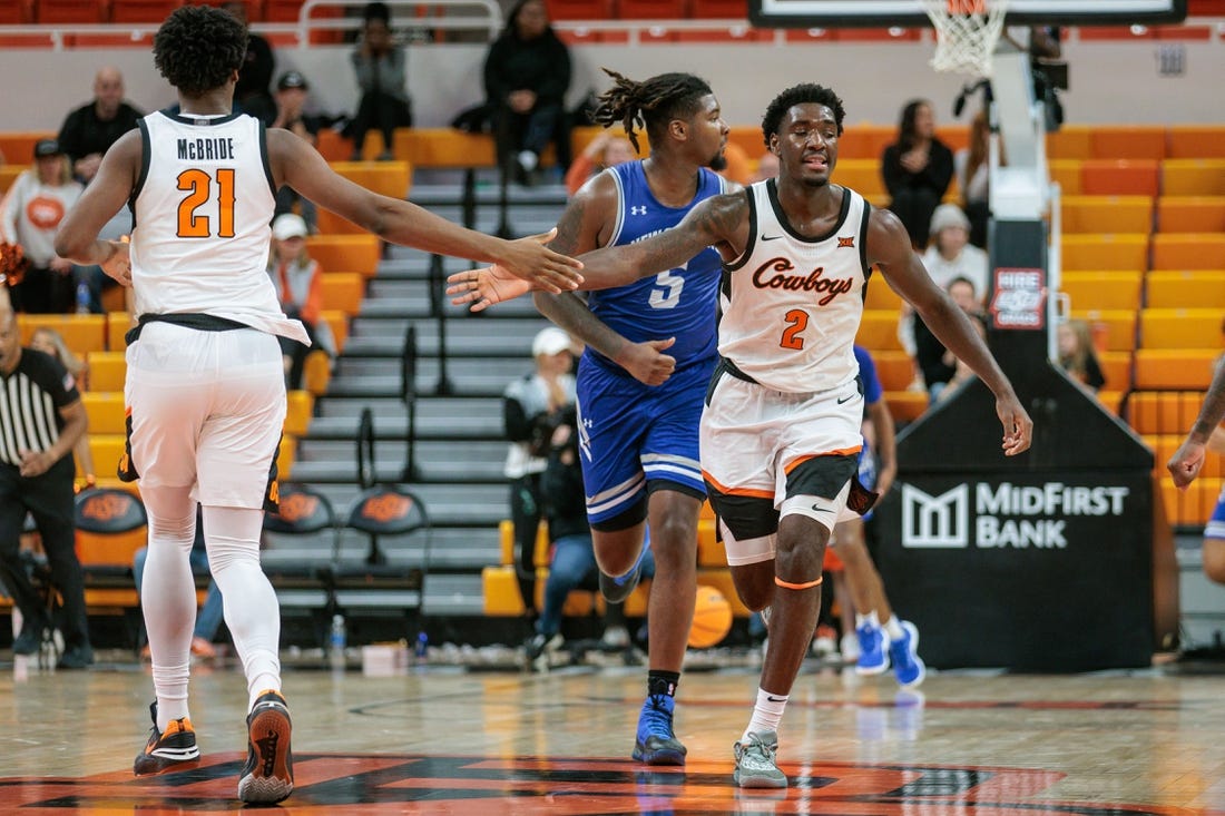 Nov 20, 2023; Stillwater, Oklahoma, USA; Oklahoma State Cowboys forward Justin McBride (21) and forward Eric Dailey Jr. (2) slap hands after a play during the second half against the New Orleans Privateers at Gallagher-Iba Arena. Mandatory Credit: William Purnell-USA TODAY Sports