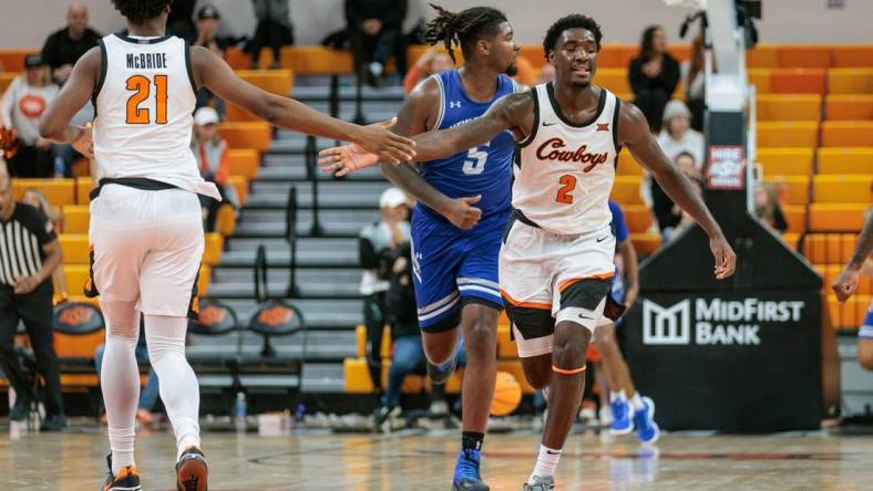 Nov 20, 2023; Stillwater, Oklahoma, USA; Oklahoma State Cowboys forward Justin McBride (21) and forward Eric Dailey Jr. (2) slap hands after a play during the second half against the New Orleans Privateers at Gallagher-Iba Arena. Mandatory Credit: William Purnell-USA TODAY Sports