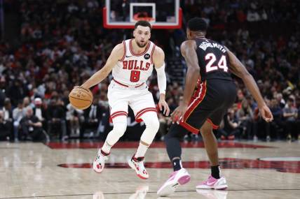 Nov 20, 2023; Chicago, Illinois, USA; Chicago Bulls guard Zach LaVine (8) brings the ball up court against Miami Heat forward Haywood Highsmith (24) during the first half at United Center. Mandatory Credit: Kamil Krzaczynski-USA TODAY Sports
