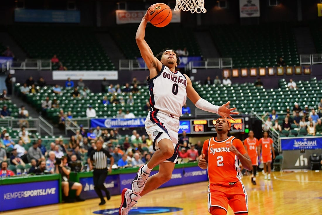 Nov 21, 2023; Honolulu, HI, USA;  

Gonzaga Bulldogs guard Ryan Nembhard (0) drives to the basket as Syracuse Orange guard JJ Starling (2) looks on during the second half at SimpliFi Arena at Stan Sheriff Center. Mandatory Credit: Steven Erler-USA TODAY Sports