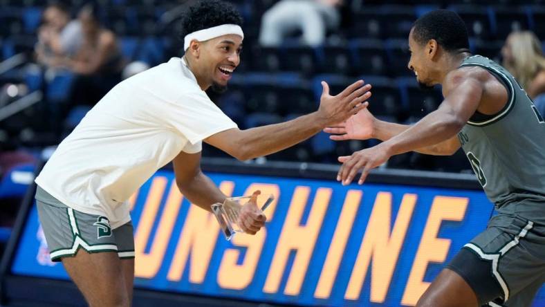 Stetson's Jalen Blackmon (left) celebrates winning the tournament MVP award with Stephan Swenson after winning the championship game with Central Michigan at the Sunshine Slam Tournament at the Ocean Center in Daytona Beach, Tuesday, Nov. 21, 2023.