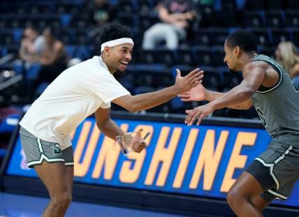 Stetson's Jalen Blackmon (left) celebrates winning the tournament MVP award with Stephan Swenson after winning the championship game with Central Michigan at the Sunshine Slam Tournament at the Ocean Center in Daytona Beach, Tuesday, Nov. 21, 2023.