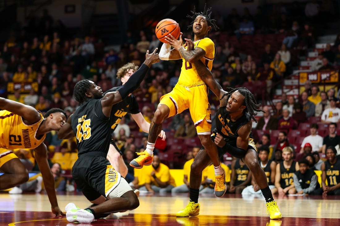 Nov 21, 2023; Minneapolis, Minnesota, USA; Arkansas-Pine Bluff Golden Lions guard Rashad Williams (5) fouls Minnesota Golden Gophers guard Elijah Hawkins (0) during the first half at Williams Arena. Mandatory Credit: Matt Krohn-USA TODAY Sports