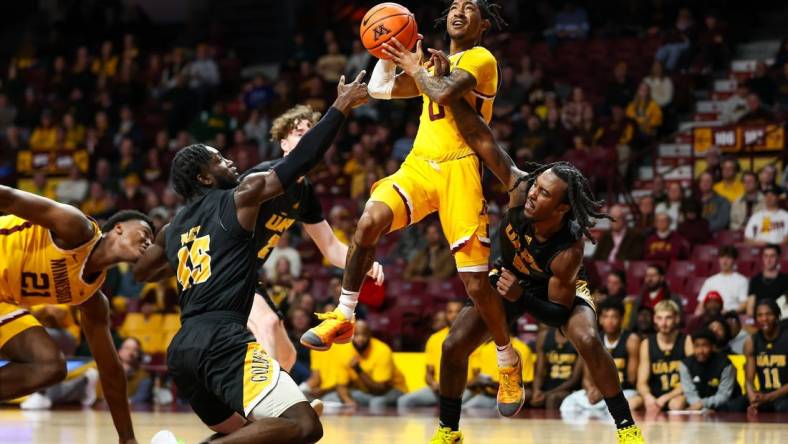 Nov 21, 2023; Minneapolis, Minnesota, USA; Arkansas-Pine Bluff Golden Lions guard Rashad Williams (5) fouls Minnesota Golden Gophers guard Elijah Hawkins (0) during the first half at Williams Arena. Mandatory Credit: Matt Krohn-USA TODAY Sports