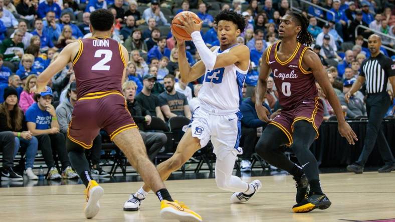 Nov 22, 2023; Kansas City, Missouri, USA; Creighton Bluejays guard Trey Alexander (23) looks for an opening during the first half between Loyola (Il) Ramblers guard Jalen Quinn (2) and Loyola (Il) Ramblers guard Desmond Watson (0) at T-Mobile Center. Mandatory Credit: William Purnell-USA TODAY Sports