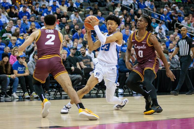 Nov 22, 2023; Kansas City, Missouri, USA; Creighton Bluejays guard Trey Alexander (23) looks for an opening during the first half between Loyola (Il) Ramblers guard Jalen Quinn (2) and Loyola (Il) Ramblers guard Desmond Watson (0) at T-Mobile Center. Mandatory Credit: William Purnell-USA TODAY Sports