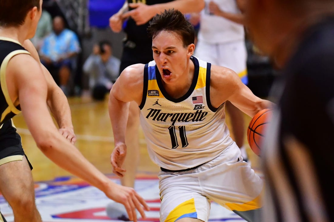 Nov 22, 2023; Honolulu, HI, USA; Marquette Golden Eagles guard Tyler Kolek (11) drives the ball down court defended by Purdue Boilermakers forward Camden Heide (23) during the second period at SimpliFi Arena at Stan Sheriff Center. Mandatory Credit: Steven Erler-USA TODAY Sports