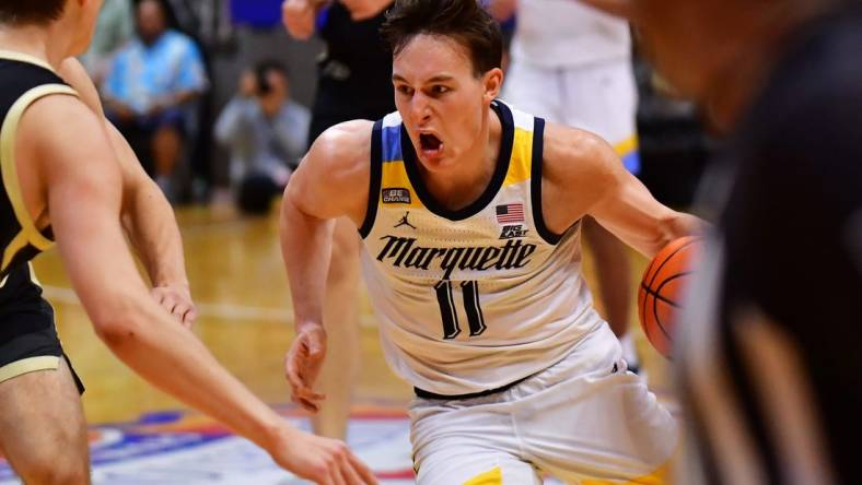 Nov 22, 2023; Honolulu, HI, USA; Marquette Golden Eagles guard Tyler Kolek (11) drives the ball down court defended by Purdue Boilermakers forward Camden Heide (23) during the second period at SimpliFi Arena at Stan Sheriff Center. Mandatory Credit: Steven Erler-USA TODAY Sports