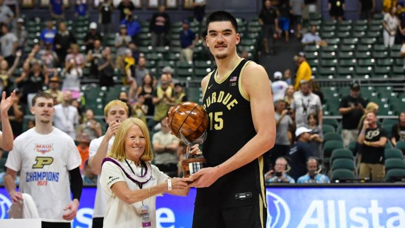 Nov 22, 2023; Honolulu, HI, USA; Purdue Boilermakers center Zach Edey (15) is presented the Most Valuable Player of the tournament by Chaminade University president Lynn Babington at SimpliFi Arena at Stan Sheriff Center. Mandatory Credit: Steven Erler-USA TODAY Sports