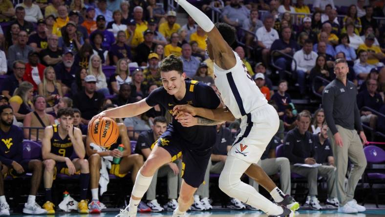 Nov 22, 2023; Fort Myers, FL, USA;  West Virginia Mountaineers forward Quinn Slazinski (11) drives to the hoop past Virginia Cavaliers guard Ryan Dunn (13) in the second half during the Fort Myers Tip-Off third place game at Suncoast Credit Union Arena. Mandatory Credit: Nathan Ray Seebeck-USA TODAY Sports