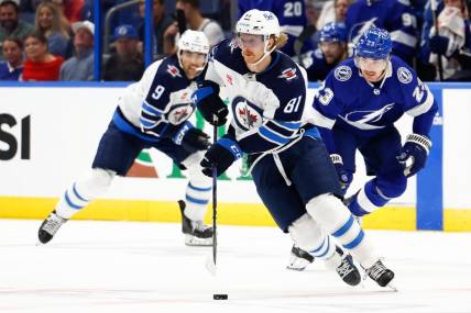 Nov 22, 2023; Tampa, Florida, USA; Winnipeg Jets left wing Kyle Connor (81) handles the puck during the second period against the Tampa Bay Lightning at Amalie Arena. Mandatory Credit: Douglas DeFelice-USA TODAY Sports