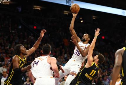 Nov 22, 2023; Phoenix, Arizona, USA; Phoenix Suns forward Kevin Durant (35) shoots the ball against the Golden State Warriors in the second half at Footprint Center. Mandatory Credit: Mark J. Rebilas-USA TODAY Sports